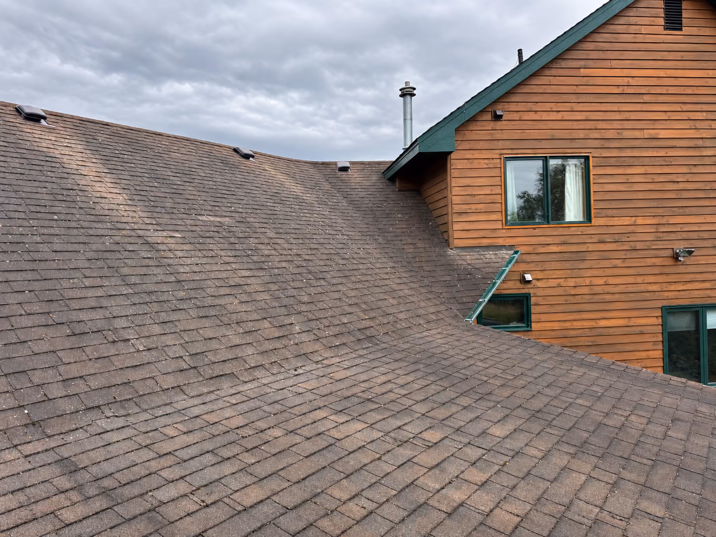 Granule loss and curled shingles on an older roof, Wasilla