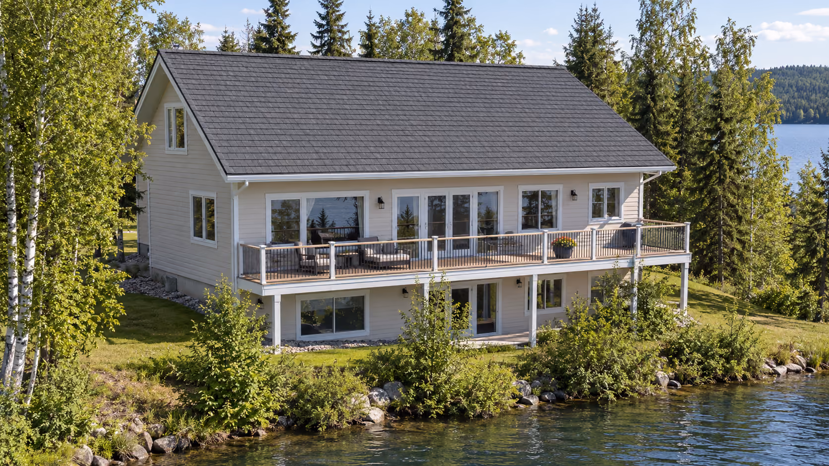 Lakefront home with a dark shingle roof and wraparound deck on Big Lake, Alaska